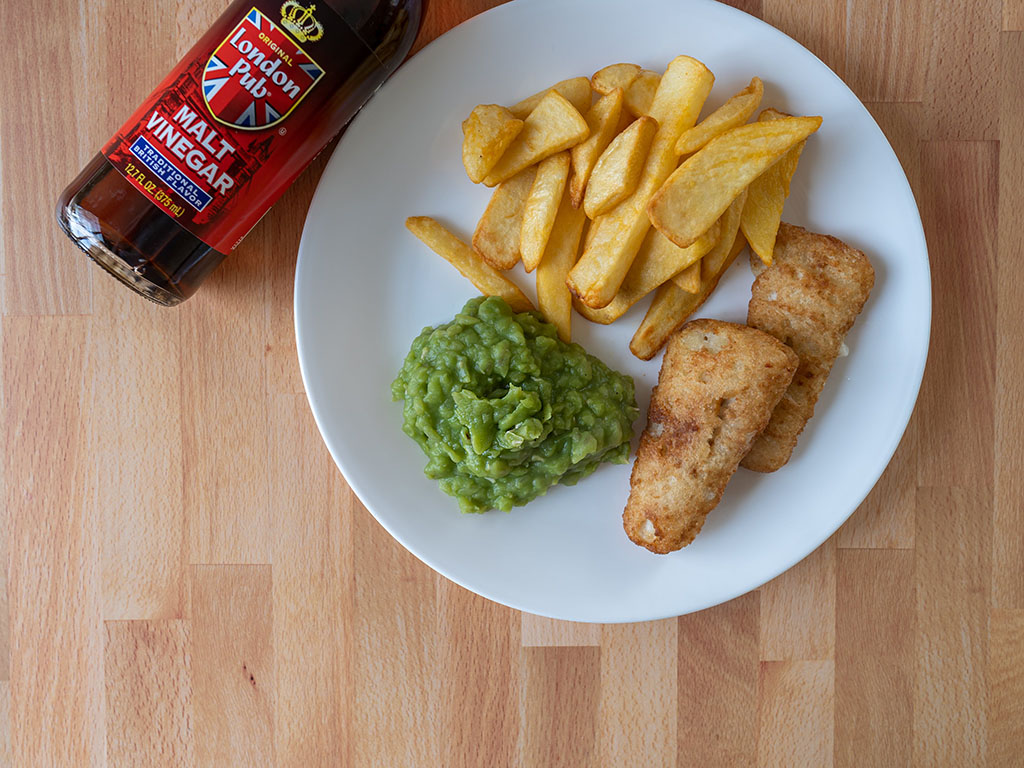 Mushy peas fish and chips and malt vinegar