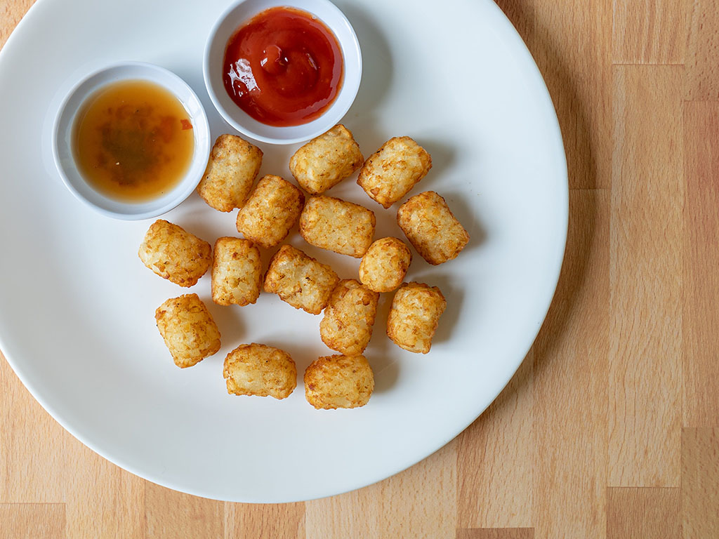 Air fried Kroger Tater Bites with ketchup and hot sauce